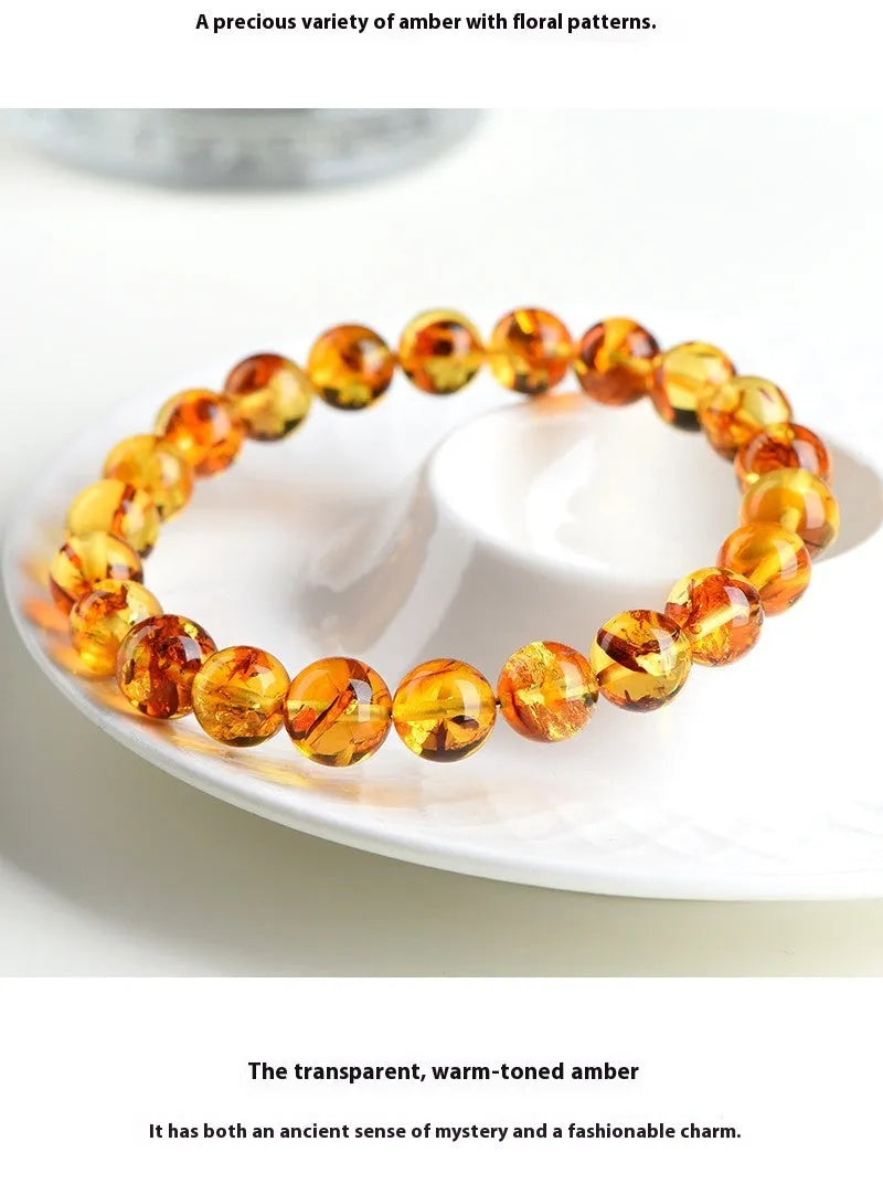 Natural yellow piebald amber geometric bracelet on a white background.