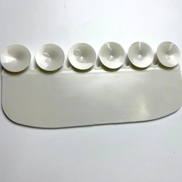 White plastic urine blocking board for toilet training placement on standard toilet bowl