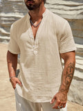 Man wearing a light blue stand collar short-sleeved casual shirt for summer.