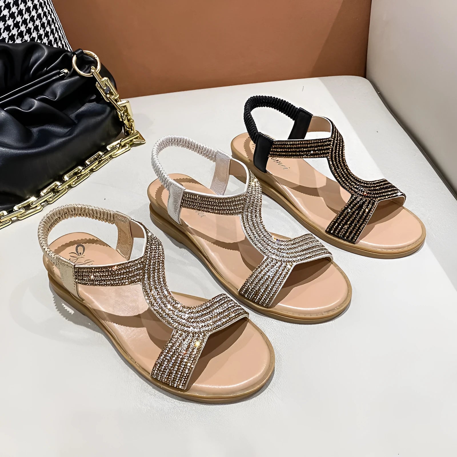 Gold women's patent leather sandals with rhinestones and a round toe on a non-slip sole.