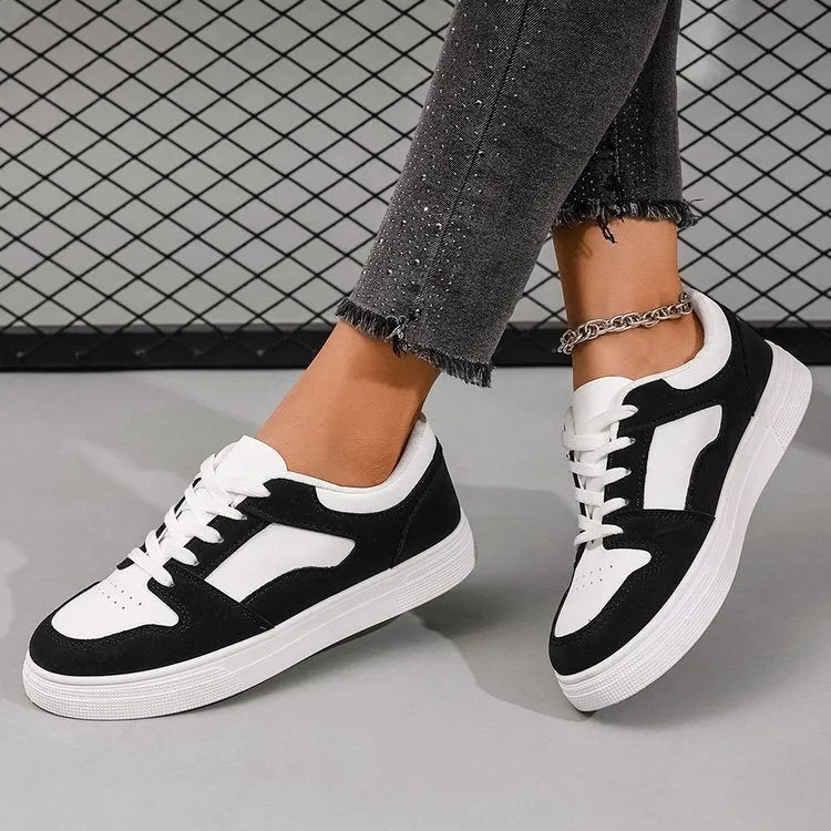 Black women's low-top casual sports shoes with a rubber sole and round toe.