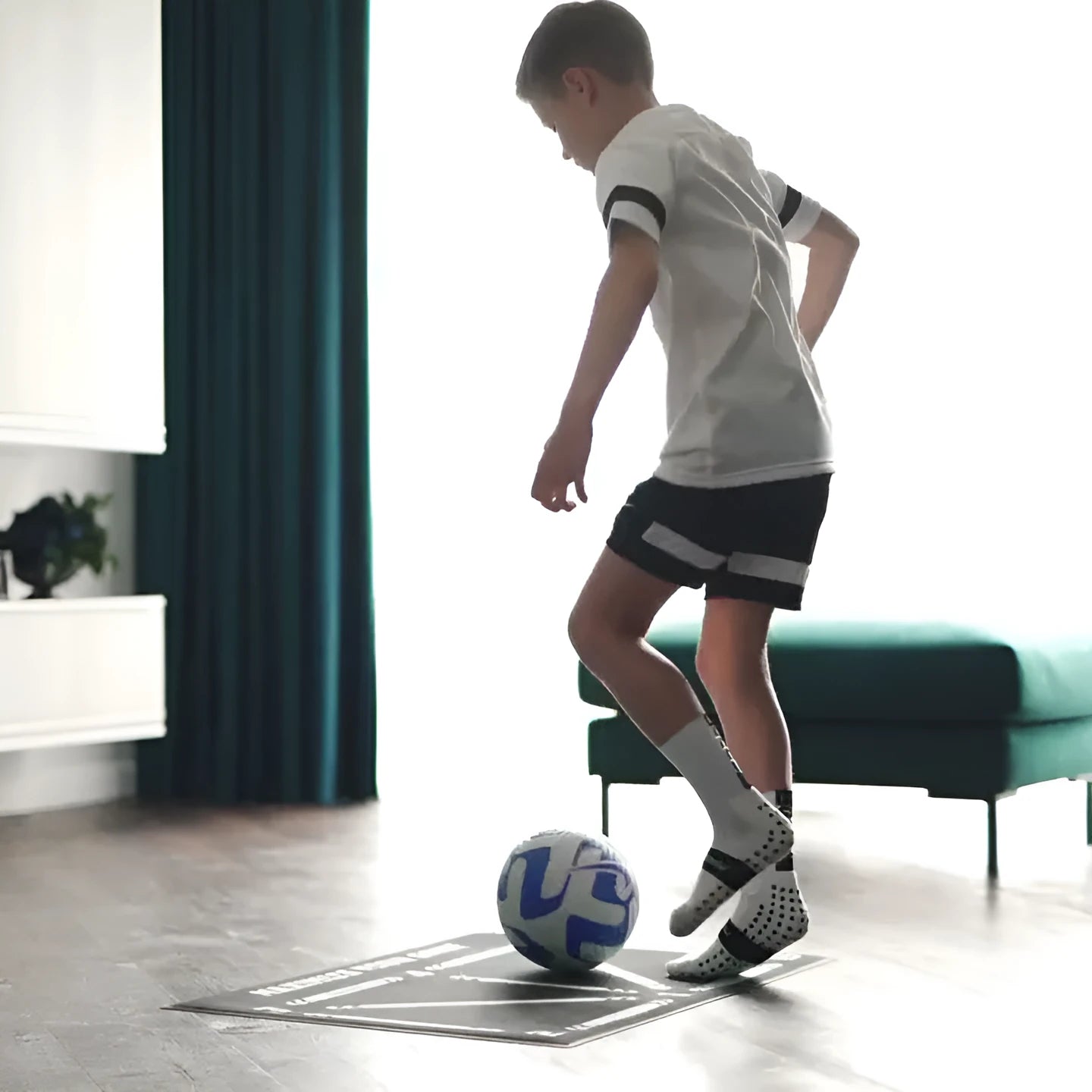 Black football training mat with non-slip rubber base measuring 60cm by 90cm