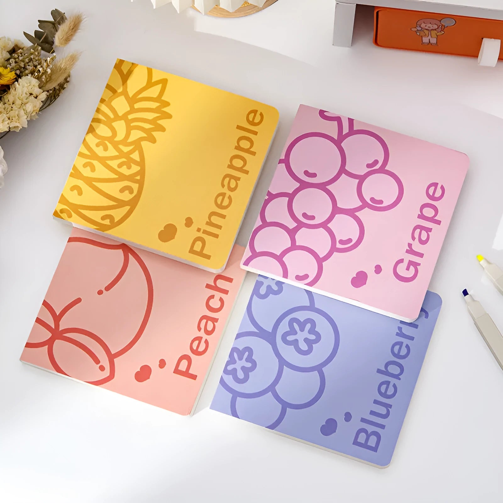 Square notebook with embossed fruit cover design showing 14.5cm dimensions and thickened paper pages