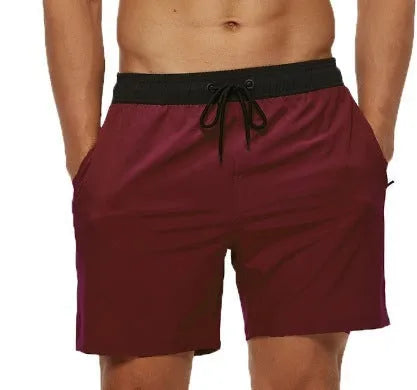 Men's blue running shorts with a stitching waistband, drawstring, and zipper pocket.
