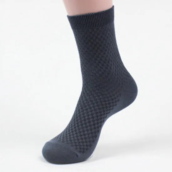 Men's bamboo fibre business socks in grey with a small-square pattern, shown on a foot.