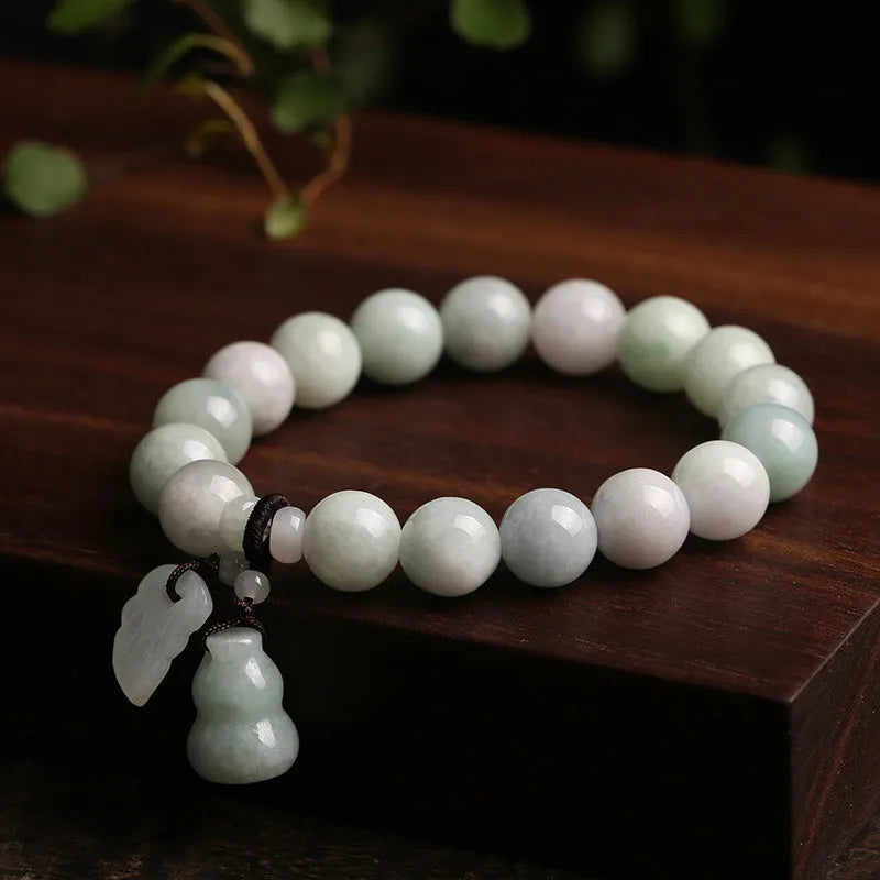 Emerald green jade hanging bracelet with Maitreya Buddha charm and geometric shapes