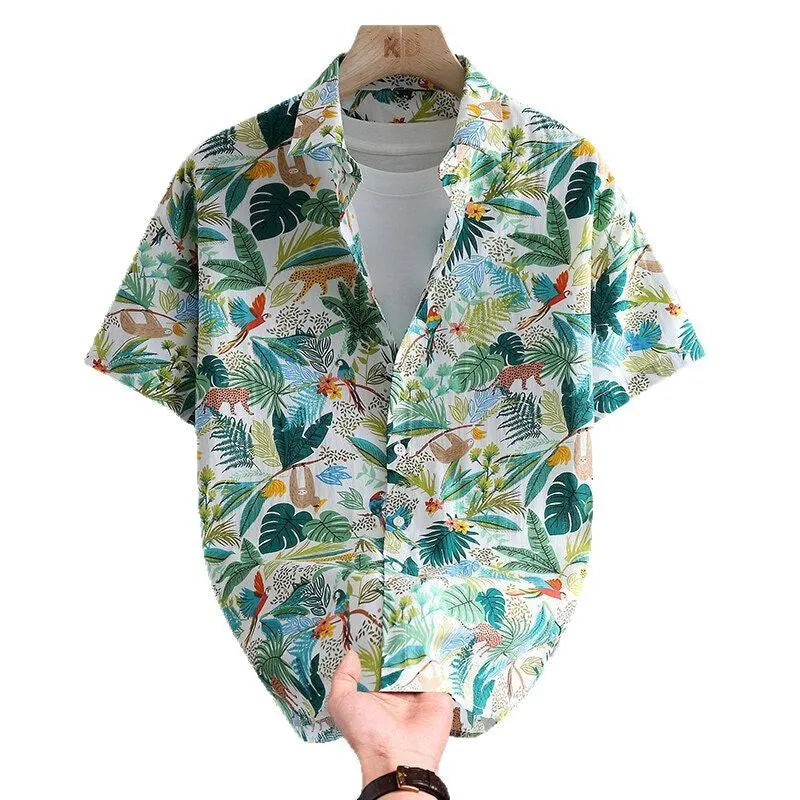Man wearing a short sleeve cotton Hawaiian shirt with a blue and white floral print.