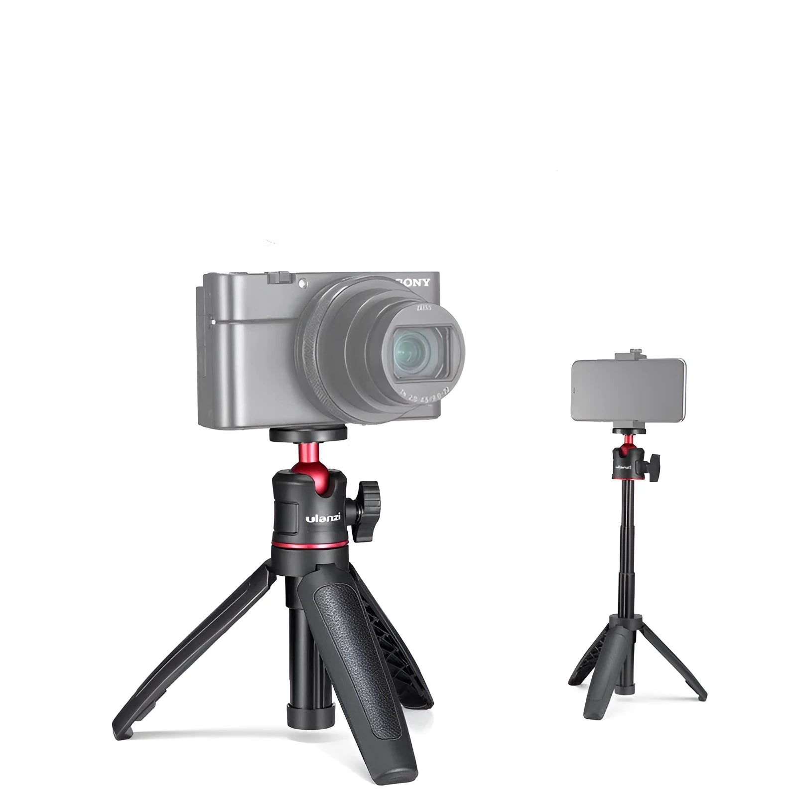 Black red and white aluminium mini tripod and extendable selfie stick for mobile phones on a desk.