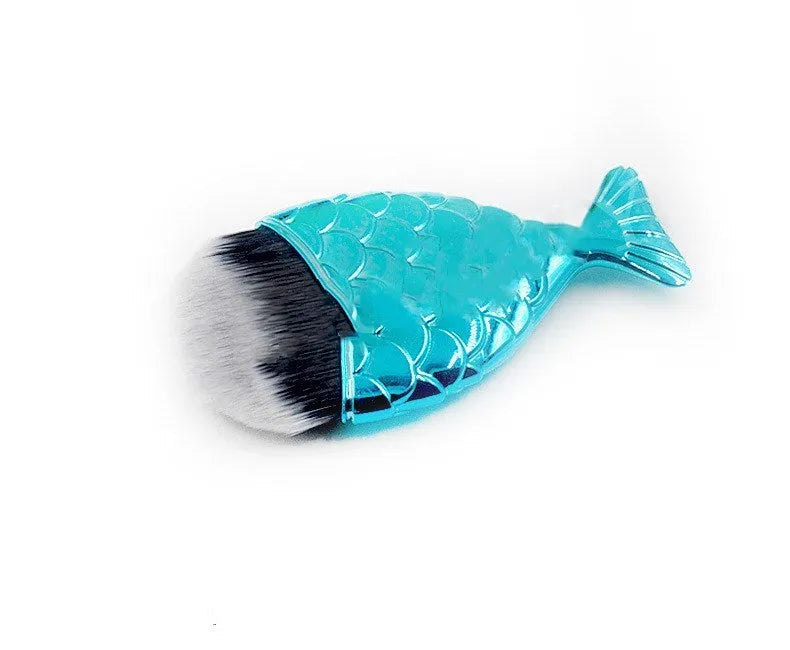 Blue fishtail makeup brush with artificial fibre bristles and short plastic handle on white background