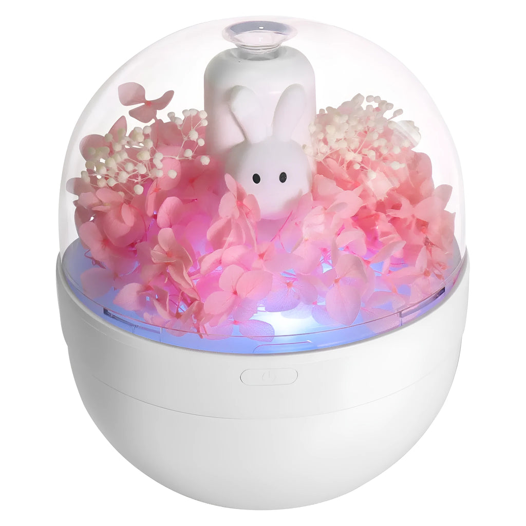 Pink rabbit-shaped aromatherapy humidifier with preserved flowers on top, USB powered for bedroom use.