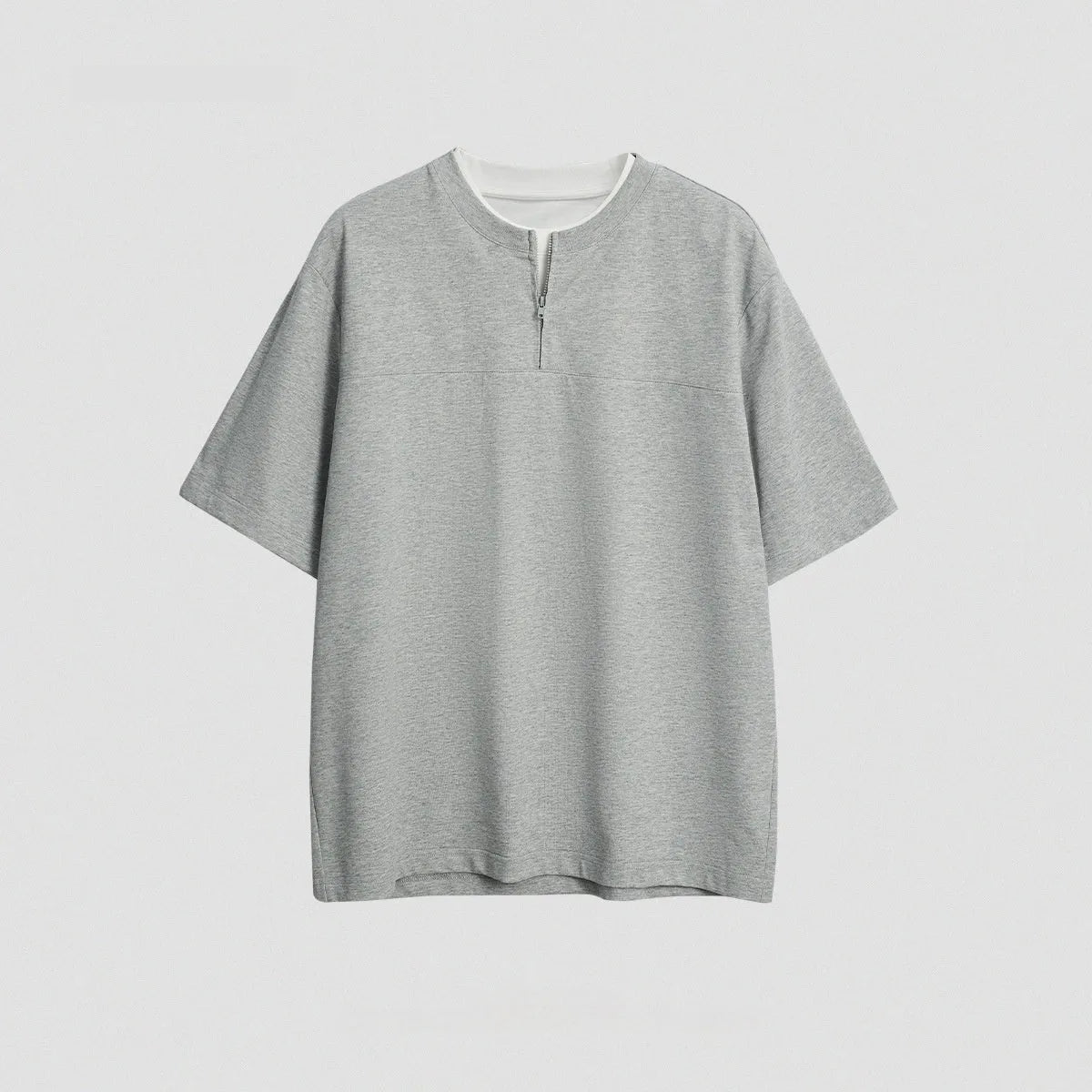 Women's loose blue patchwork top with false two-piece design on a hanger.