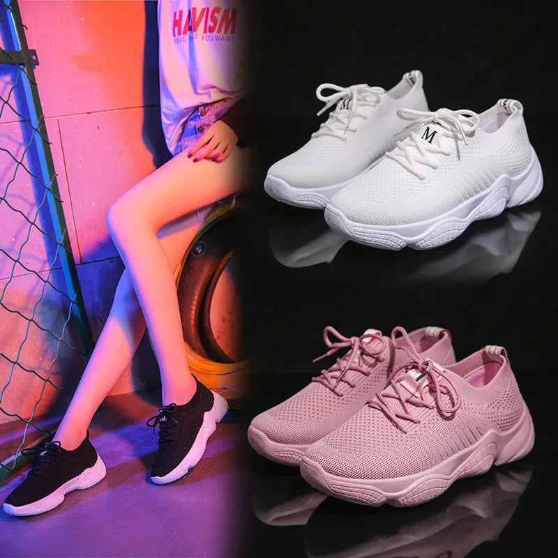 Women's white thick-soled flying woven trainers with pink perforations and a front strap on a rubber sole.