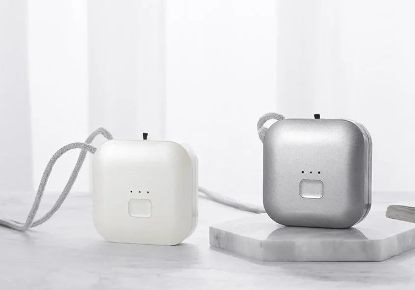 Mini USB rechargeable air purifier necklace in blue, shown with charging cable.