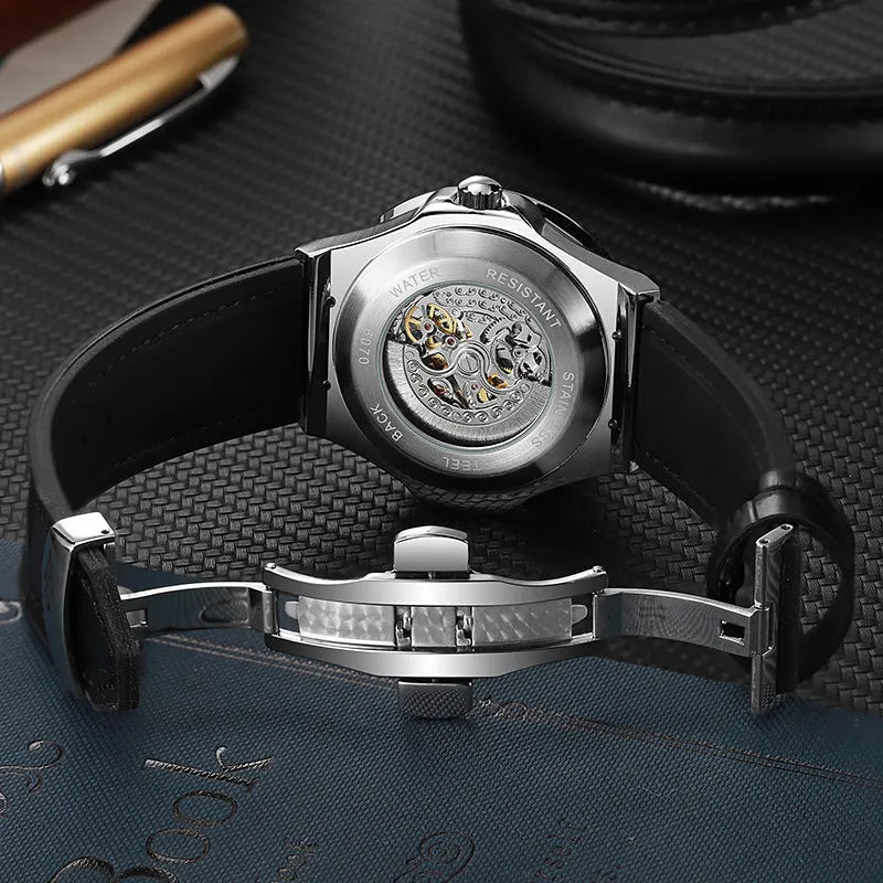 Men's automatic skeleton watch with diamond accents on dial, stainless steel case, leather strap.