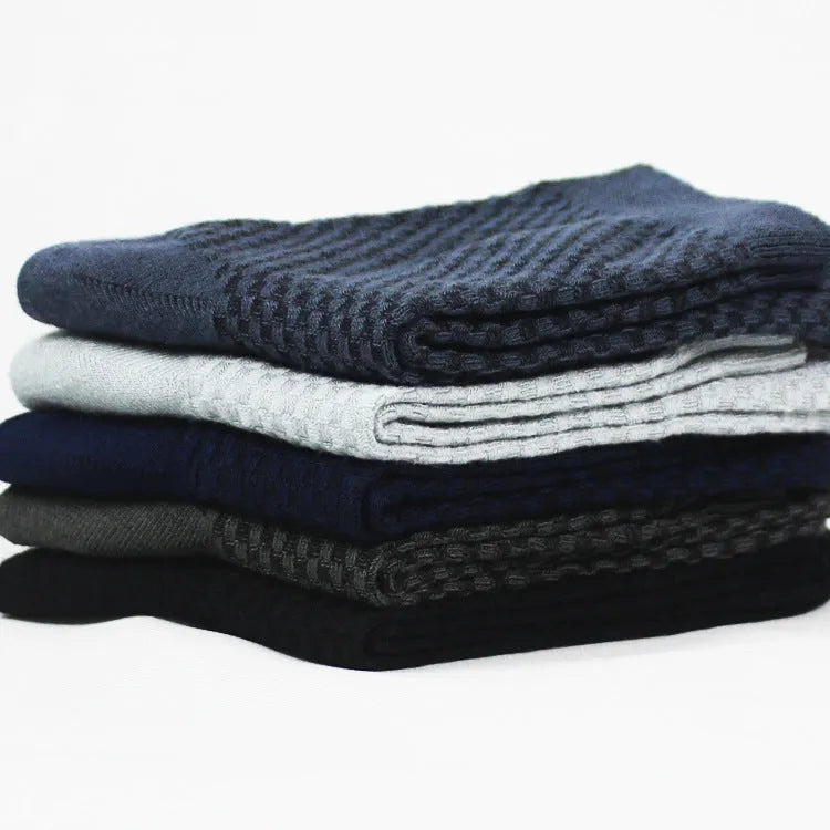 Men's bamboo fibre business socks in grey with a small-square pattern, shown on a foot.