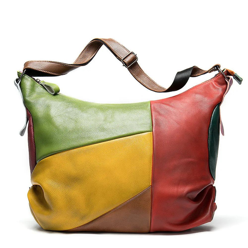Men's brown cowhide leather travel bag with stitching detail, shown as a crossbody bag with laptop compartment.