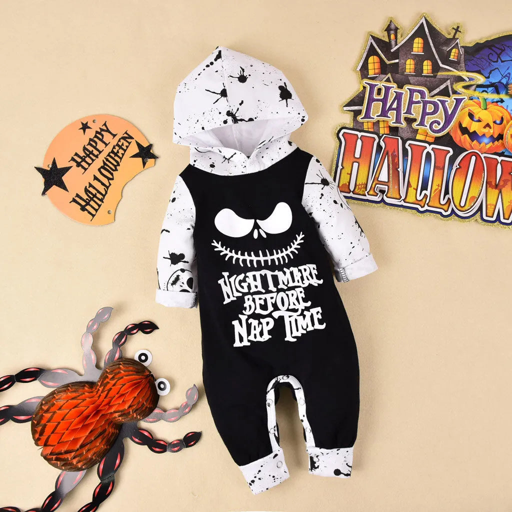 Black or brown cotton Halloween romper with long sleeves and a hood, laid flat.