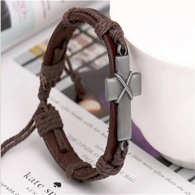Brown leather cross bracelet with first layer cowhide and alloy accents on a neutral background