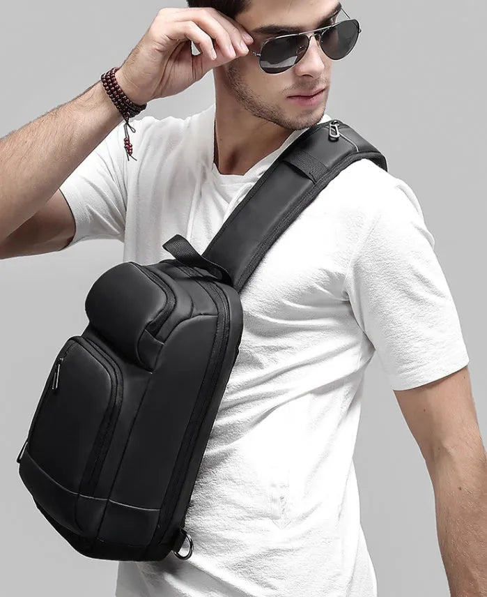 Black medium outdoor shoulder bag with air cushion strap showing internal laptop and organiser pockets