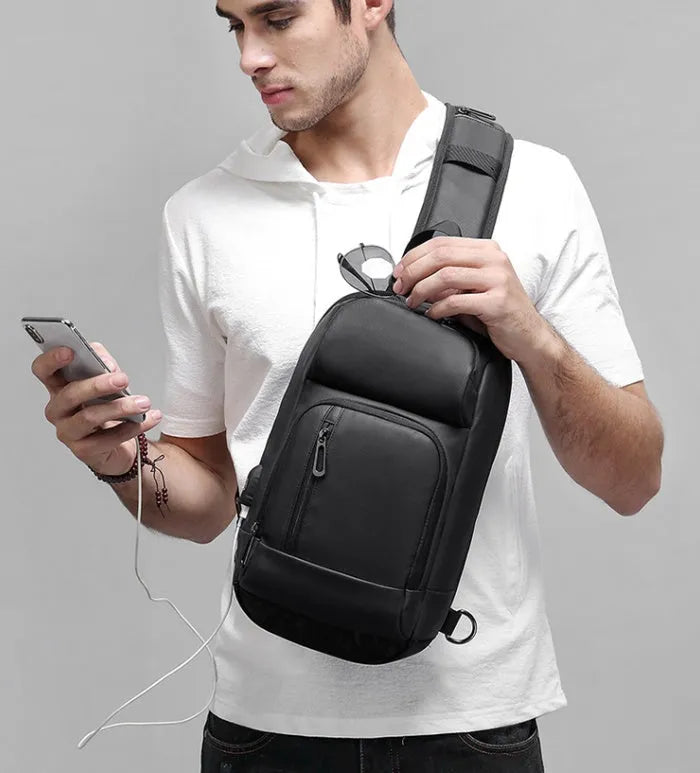 Black medium outdoor shoulder bag with air cushion strap showing internal laptop and organiser pockets