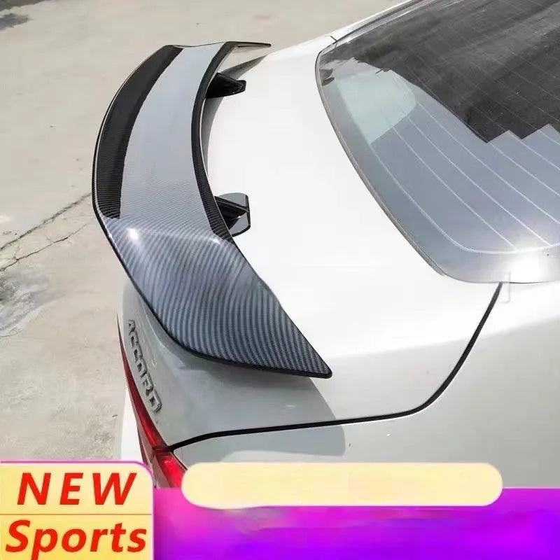 Universal punch-free car tail wing spoiler in ABS plastic shown in bright black and carbon pattern finishes.