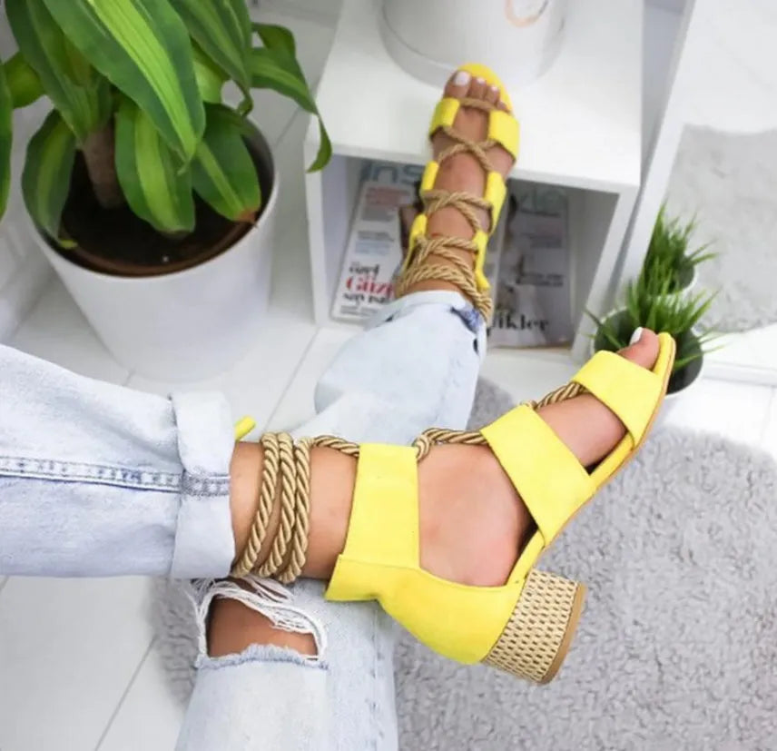 Women's beige suede sandals with thick middle heel, fish mouth toe, and ankle strap.