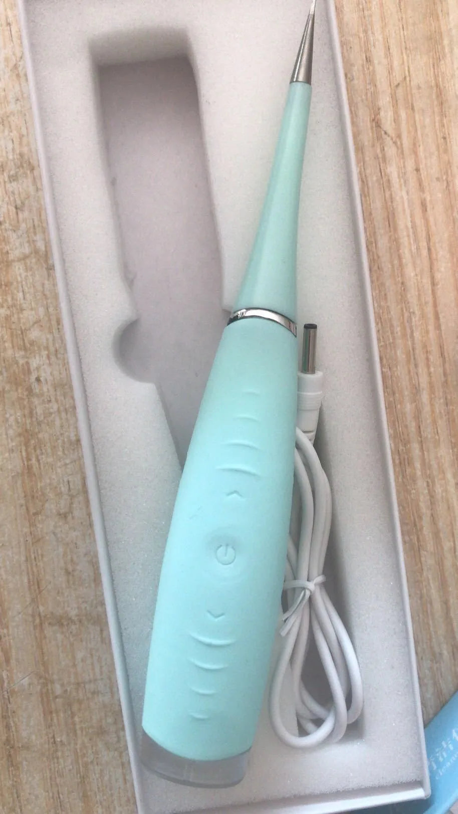 Pink and blue waterproof electric dental calculus remover tool on a white background