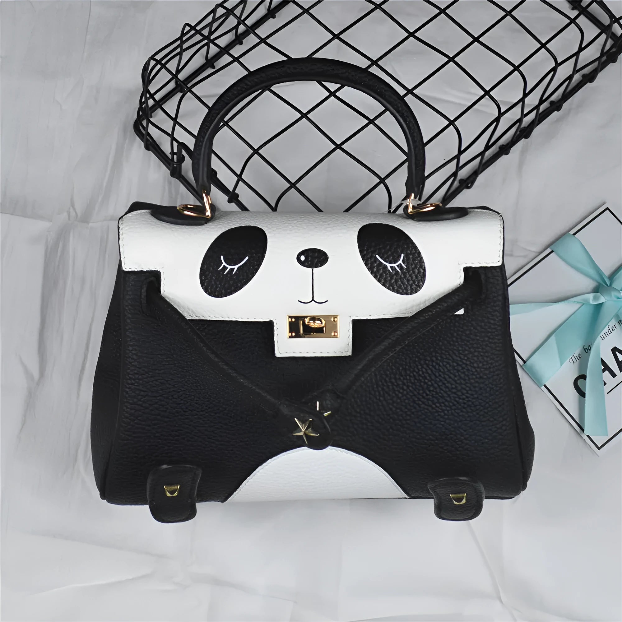 A square cow leather handbag with a sweet panda animal print, shown in two size options.