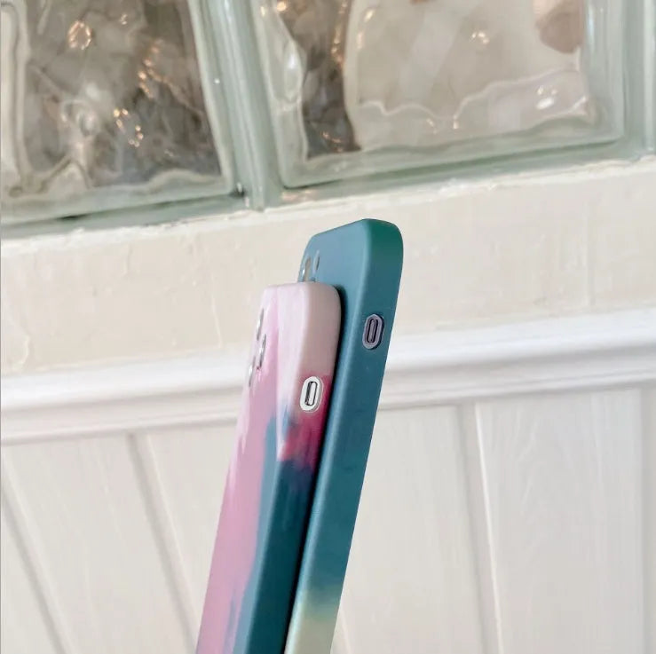 Soft silicone iPhone case with a blue and purple gradient geometric abstract pattern, shown on a phone.