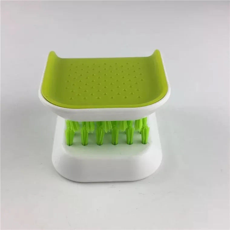 Blue U-shaped plastic brush with bristles for cleaning knives and cutlery in a kitchen.
