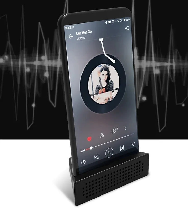 Portable black ABS mobile phone amplifier bracket holding an iPhone on a desk