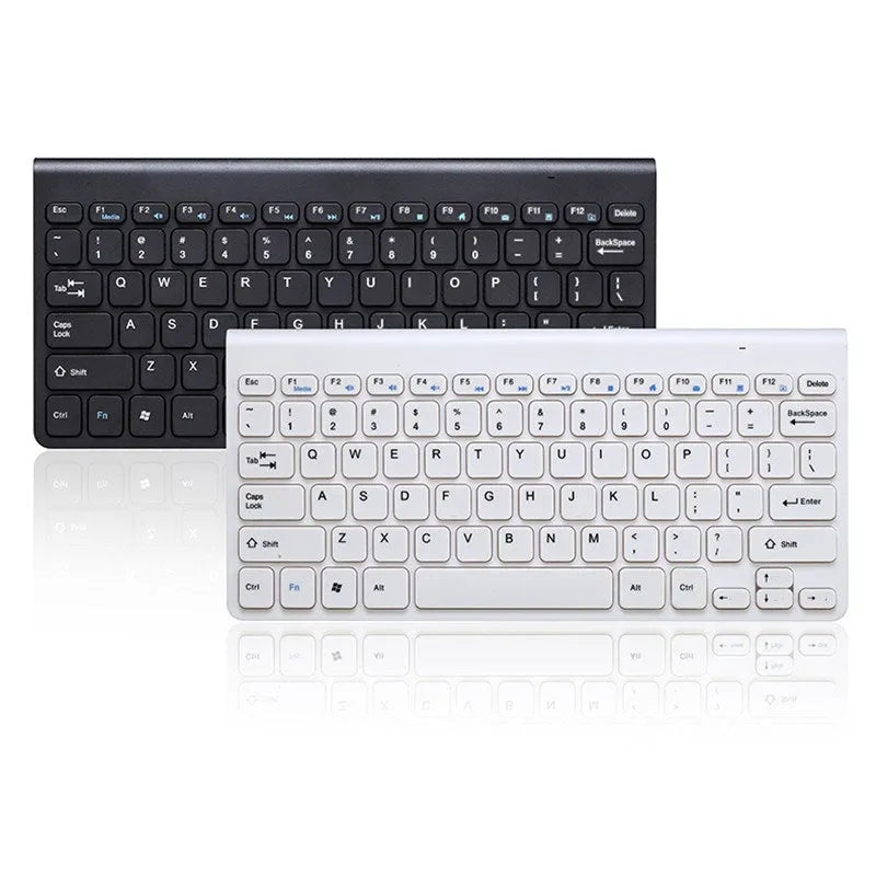 Black and white wireless keyboard and mouse set with USB receiver on a wooden desk.