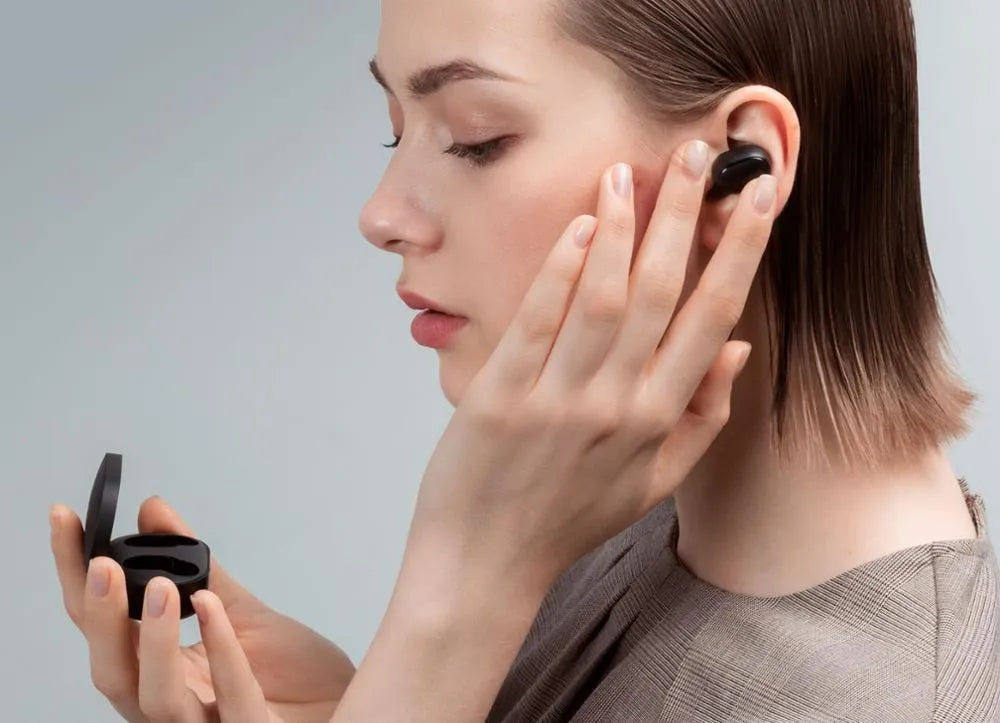 Redmi AirDots black true wireless Bluetooth headphones and charging case.
