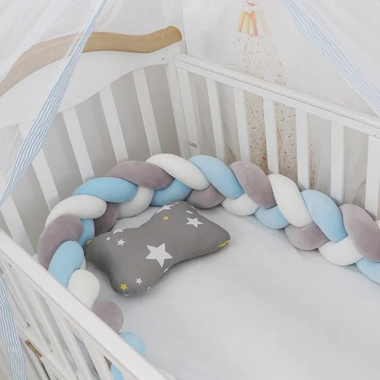 Baby crib bumper protector in spandex velvet, bent to show flexible shape, against a crib rail.