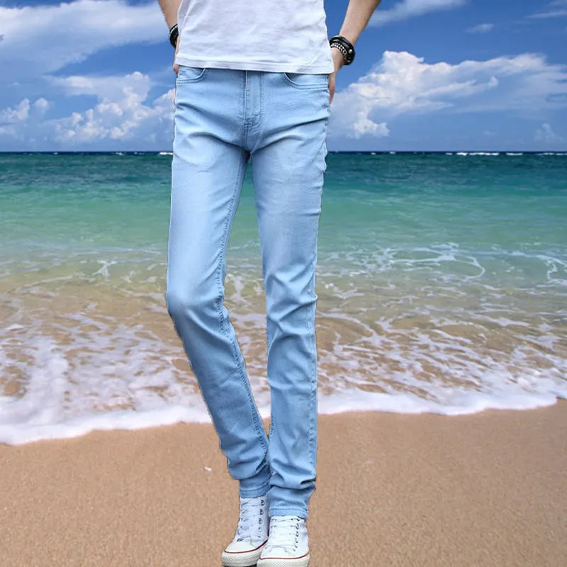 Thin men's loose skinny casual jeans in pure black with low waist, cropped leg, small leg opening, and zip fly.