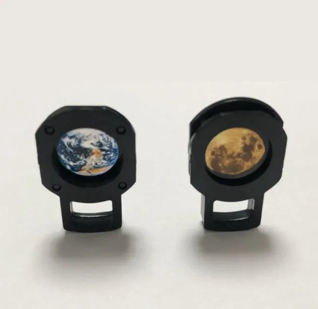 Adjustable Earth and Moon projection night light with USB cable on a desk