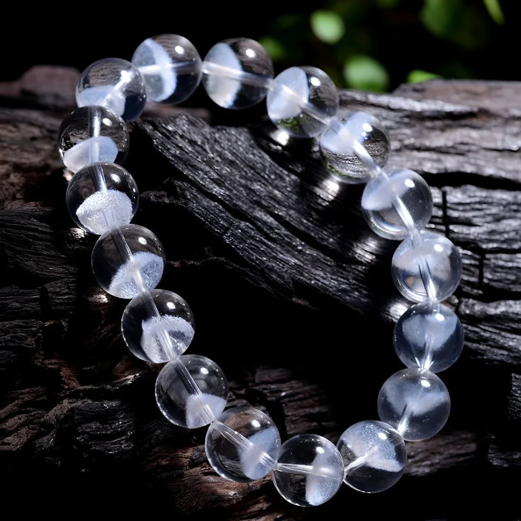 Women's white crystal pyramid bracelet with Ruyi symbol, showing polished beads.