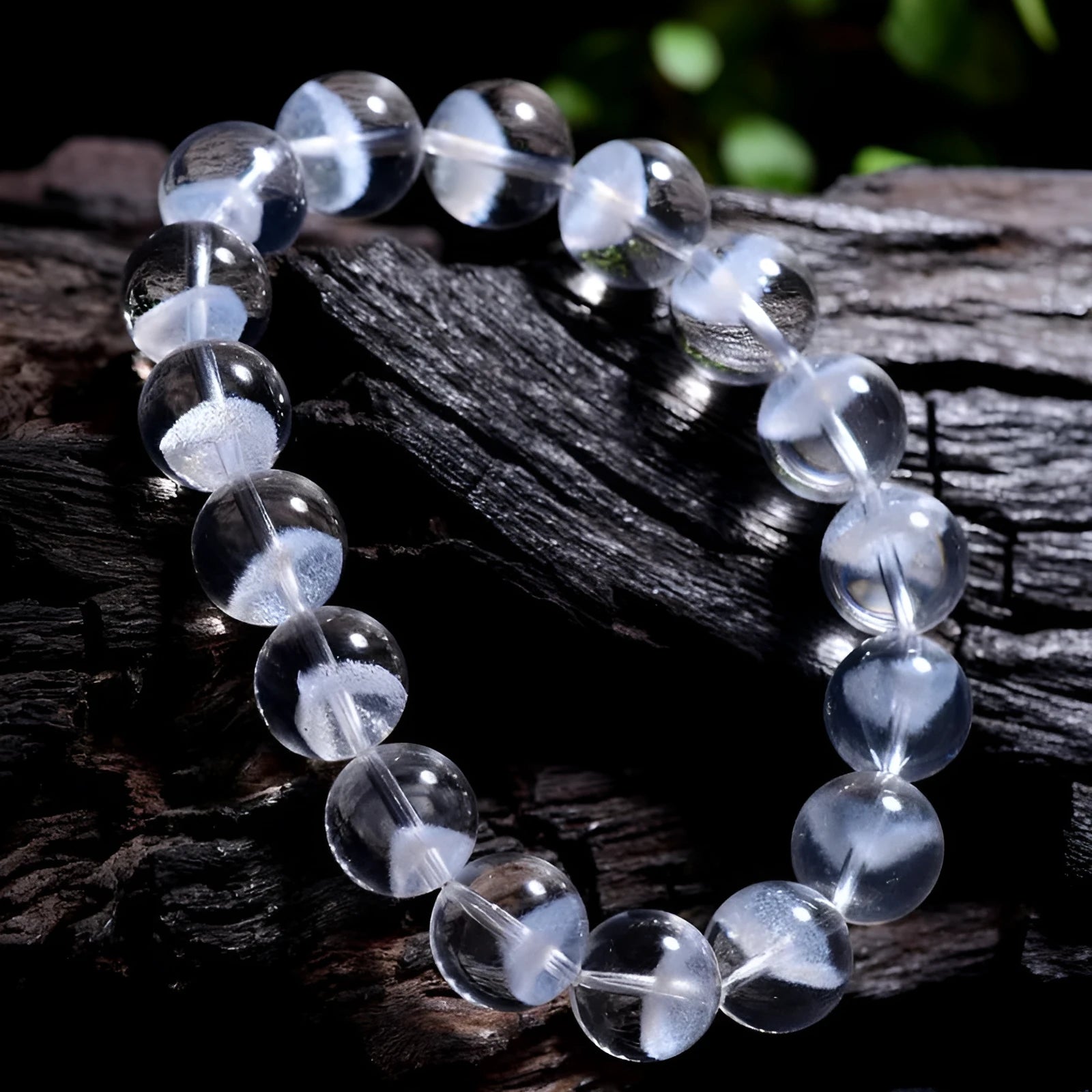 Women's white crystal pyramid bracelet with Ruyi symbol, showing polished beads.