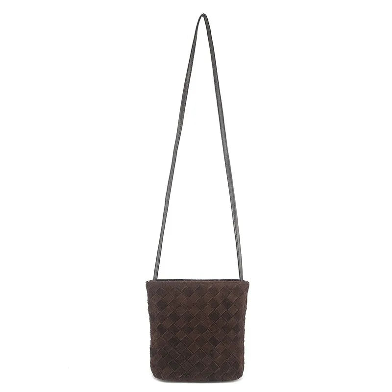 Cowhide leather barrel-shaped zip crossbody bag in black with weaving detail and crossbody strap
