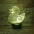 Little yellow duck 3D night light showing colourful LED illumination on a table with remote control.