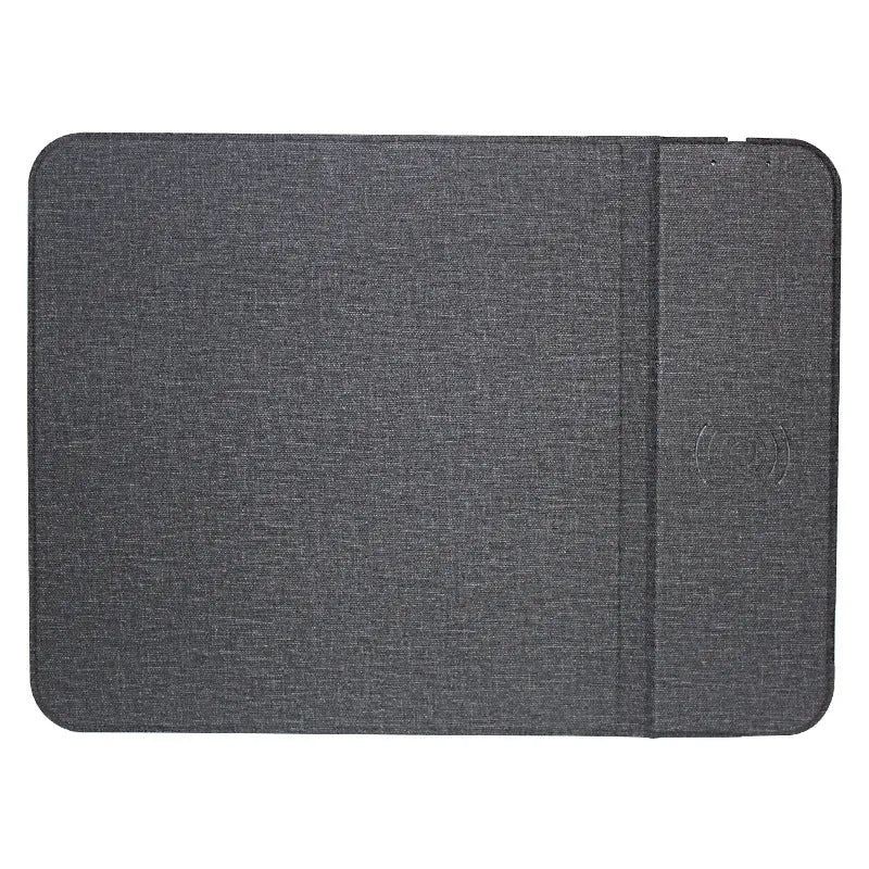Foldable cloth phone holder with built-in wireless charging pad on a desk.