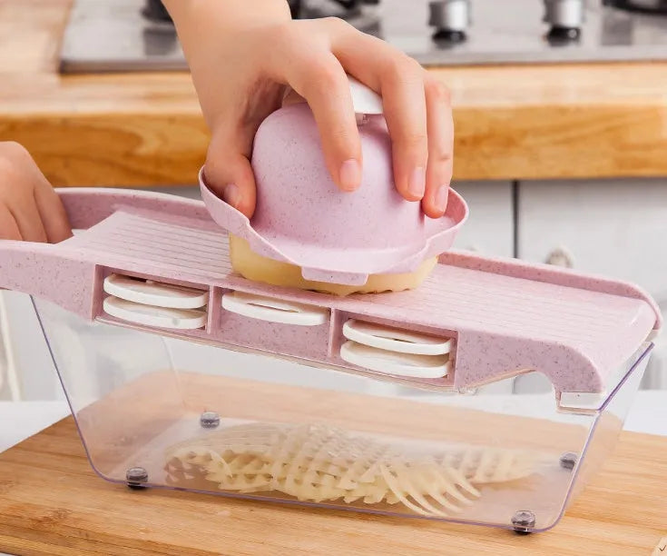 Multifunctional vegetable cutter with seven stainless steel blades on a kitchen counter