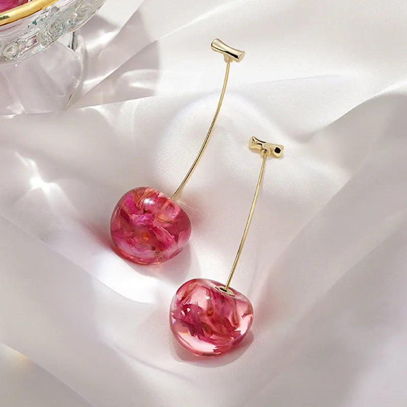Long red French dried cherry earrings for women in plated alloy design on white background