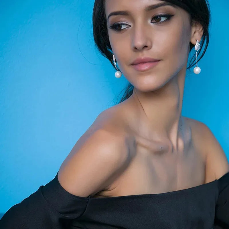 Silver angel wing earrings with diamond treatment and gold-plated gemstone inlay in platinum colour