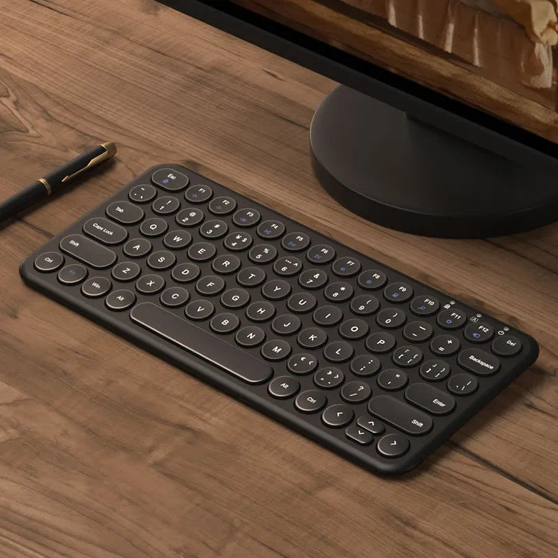 Ultra-thin white wireless keyboard and mouse set with USB receiver on a desk.