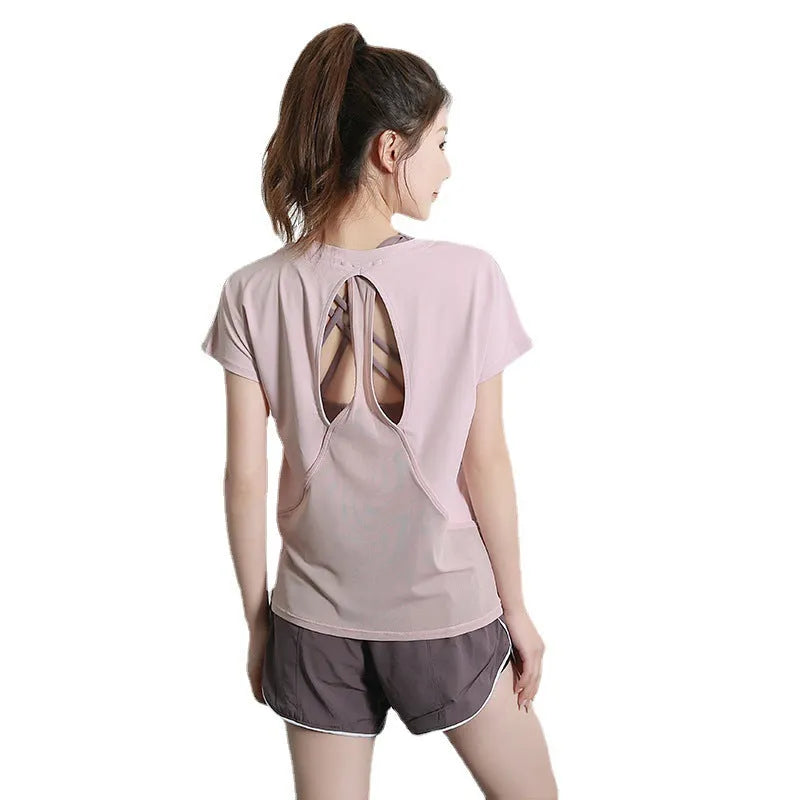 Women's short sleeve polyester sports t-shirt in pink, shown for running and fitness.
