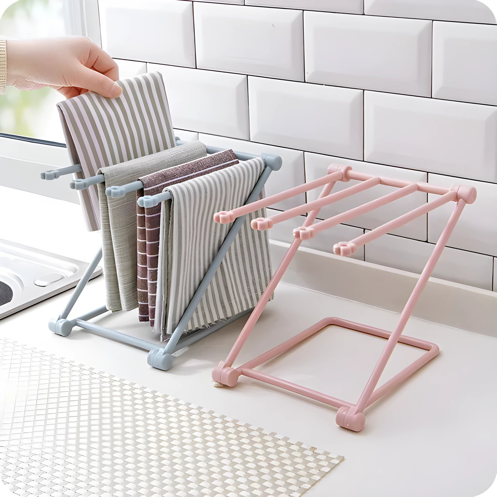 Light grey foldable plastic dishcloth shelf on a kitchen countertop