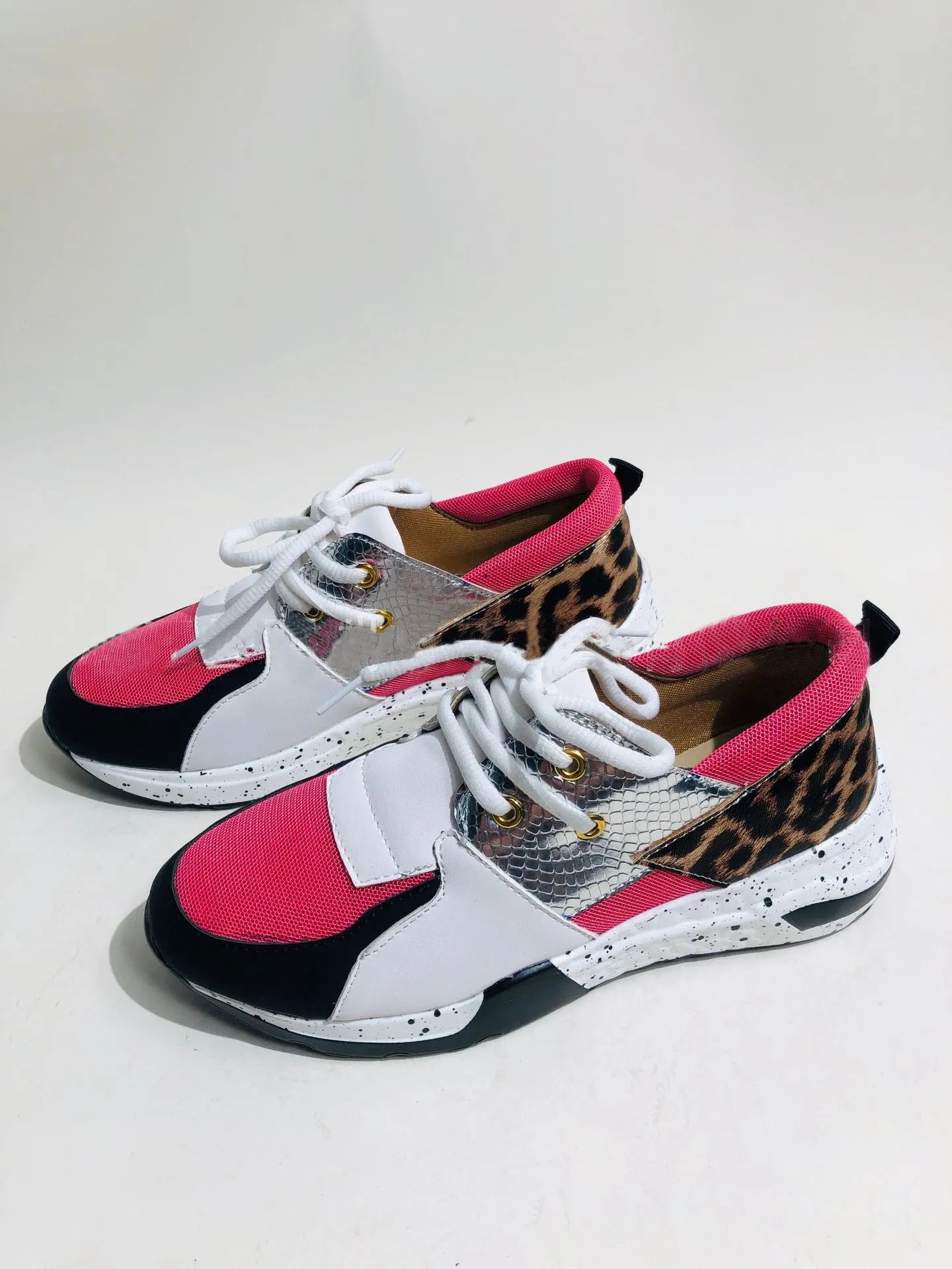 Women's suede casual flat sneakers with a wedge heel in leopard print.