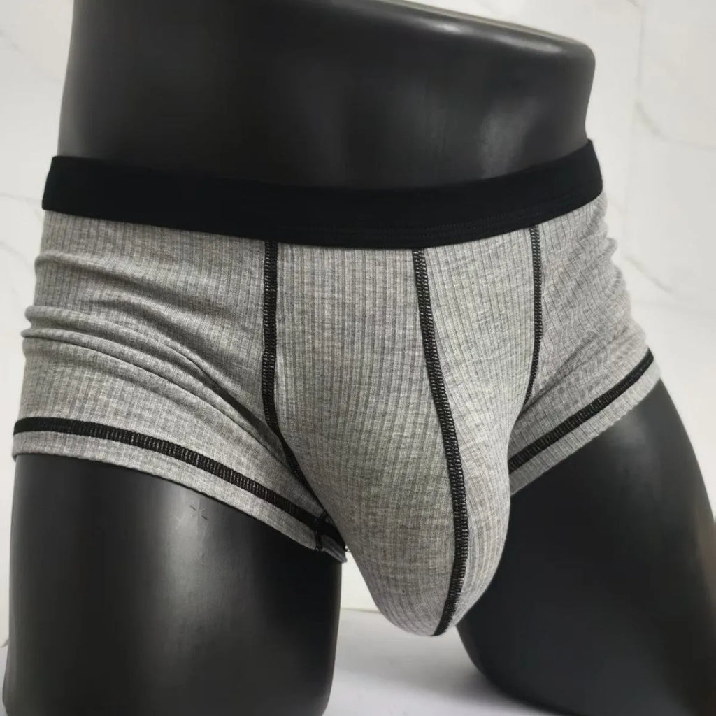Men's solid colour boxer shorts in thin fabric, shown in army green, highlighting breathable and body-shaping design.
