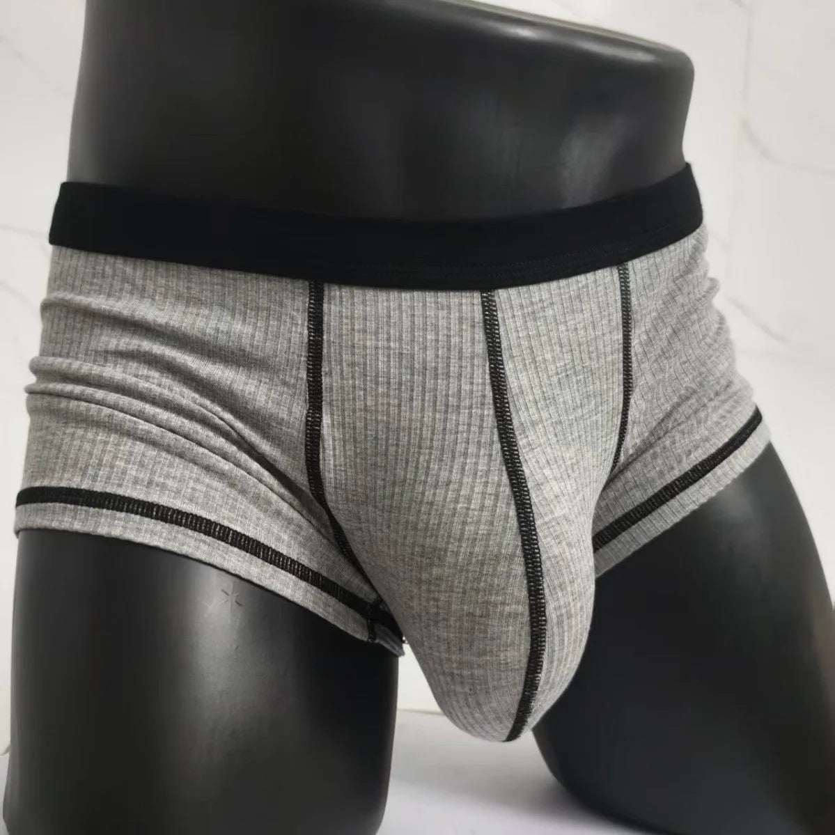 Men's solid colour boxer shorts in thin fabric, shown in army green, highlighting breathable and body-shaping design.